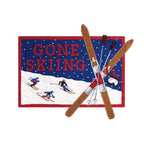Embroidered patch with 'Gone Skiing' text and skiers on a blue background.