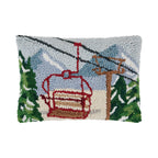 Decorative pillow with a ski lift design on a white background