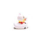 White cat figurine with colorful bow tie on a white background