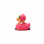 Pink rubber duck with a green hat on a white background