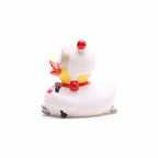 White duck figurine with red comb and yellow wattle on a white background