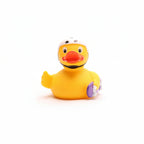 Yellow rubber duck with a helmet and goggles on a white background